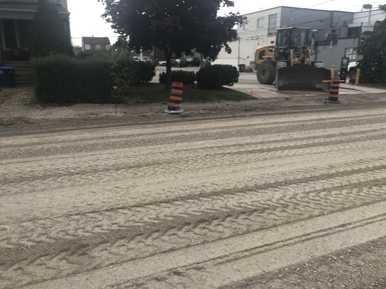 Loader grading road base